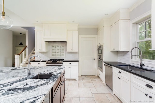 kitchen featuring sink, decorative light fixtures, decorative backsplash, and appliances with stainless steel finishes