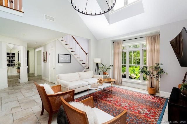 living room featuring a chandelier and high vaulted ceiling