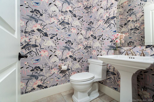 bathroom with toilet and tile patterned flooring