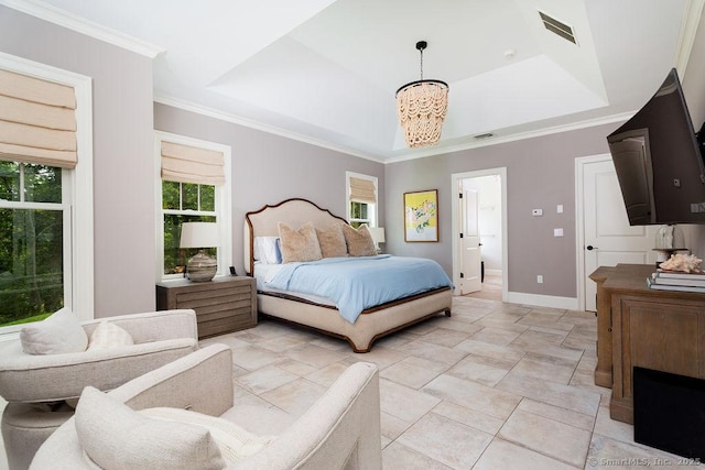 bedroom with ensuite bathroom, crown molding, an inviting chandelier, and a tray ceiling