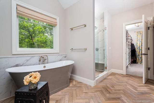 bathroom featuring independent shower and bath, vaulted ceiling, and parquet floors