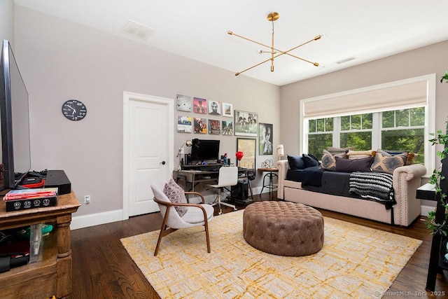 living room with dark hardwood / wood-style flooring and a chandelier