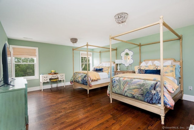 bedroom with dark wood-type flooring