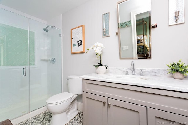 bathroom with tile patterned floors, vanity, toilet, and a shower with shower door