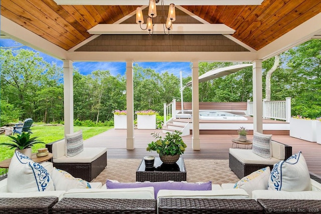 view of patio / terrace with a gazebo, an outdoor living space, a hot tub, and a deck