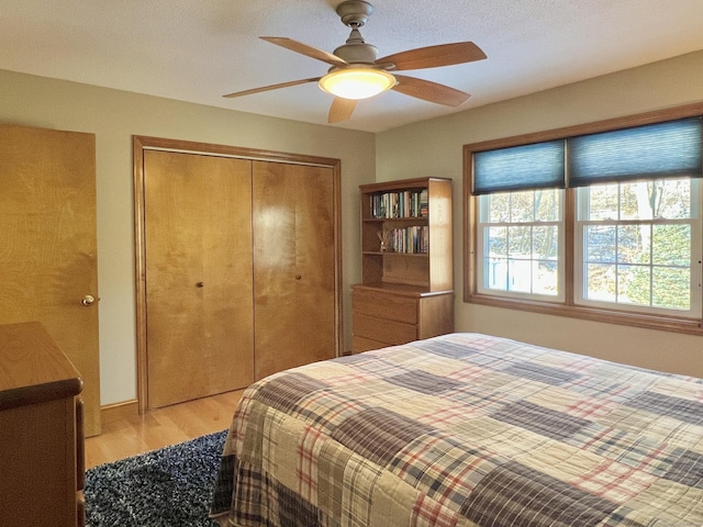 bedroom featuring a closet, ceiling fan, and light wood-type flooring