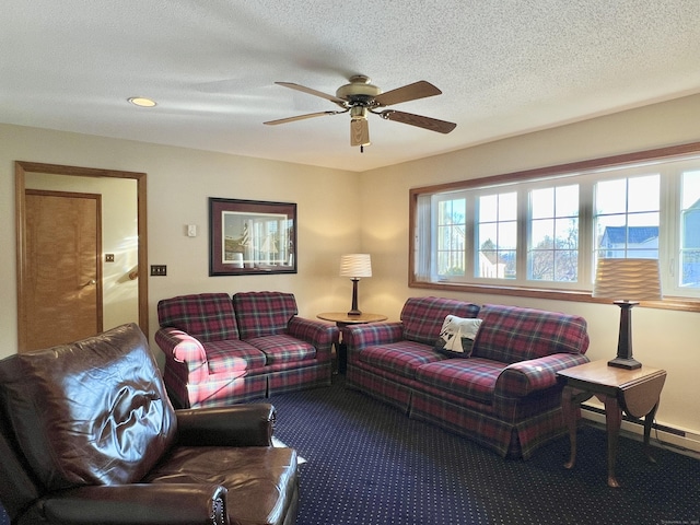 carpeted living room featuring ceiling fan, a baseboard heating unit, and a textured ceiling