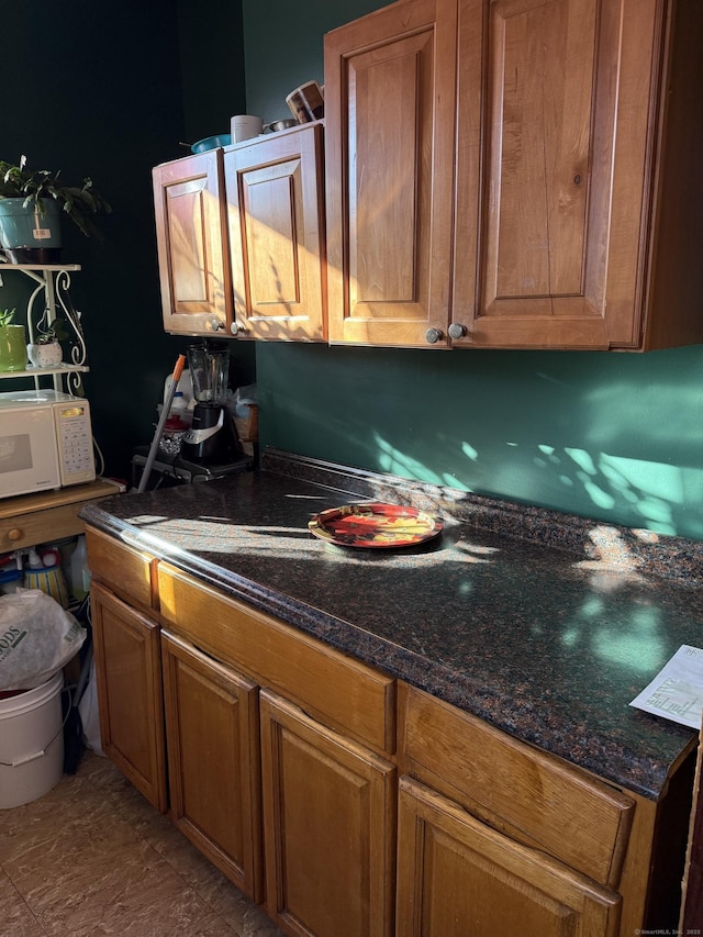 kitchen featuring dark stone counters