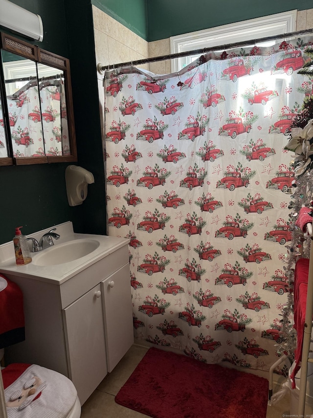 bathroom with walk in shower, vanity, and tile patterned flooring