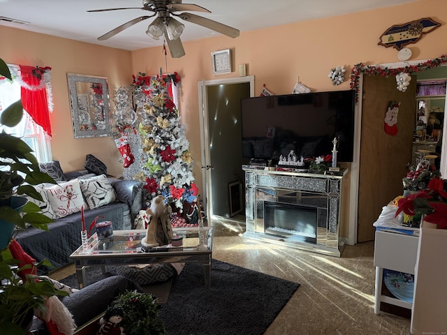 living room with ceiling fan and carpet