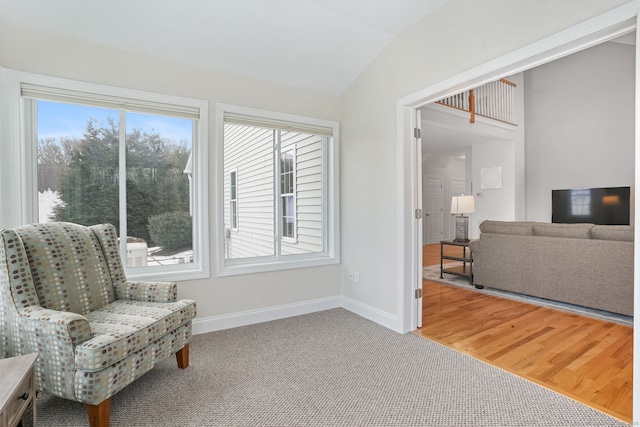 sitting room with vaulted ceiling and carpet