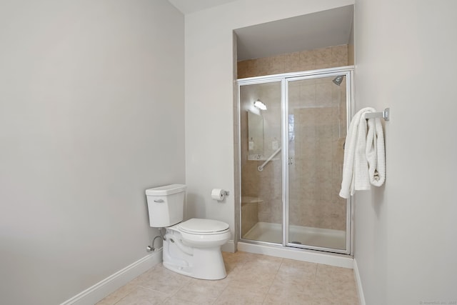 bathroom featuring a shower with shower door, tile patterned floors, and toilet