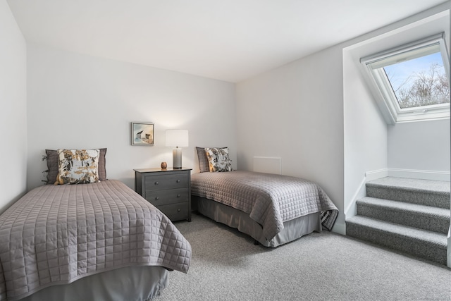 bedroom featuring carpet flooring and a skylight