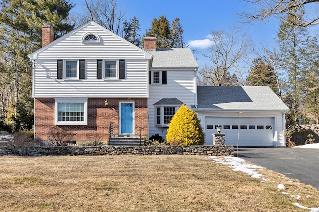 front of property with a garage and a front lawn