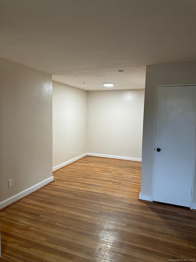 empty room featuring dark wood-type flooring