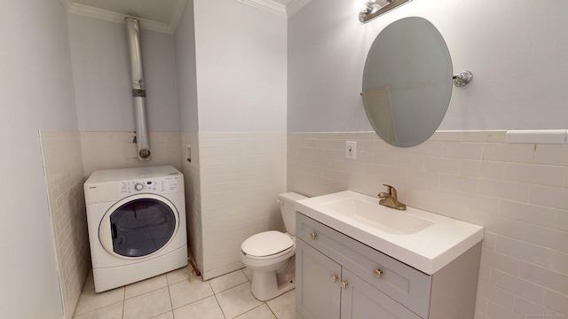 bathroom with washer / dryer, vanity, ornamental molding, toilet, and tile patterned floors