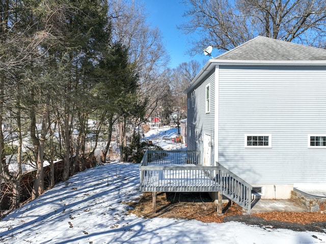 view of snow covered exterior featuring a deck