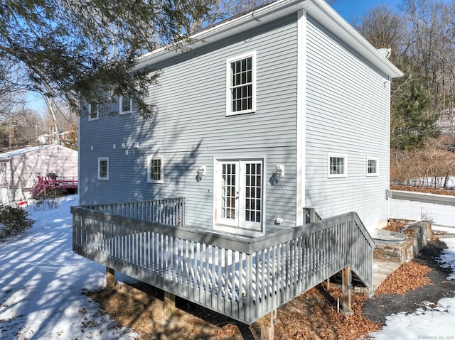 snow covered property with a deck