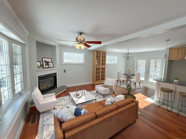 living room featuring hardwood / wood-style flooring, ornamental molding, plenty of natural light, and french doors