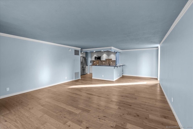 unfurnished living room featuring light hardwood / wood-style flooring and ornamental molding