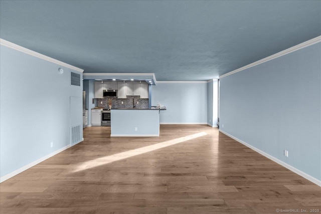 unfurnished living room featuring ornamental molding and light hardwood / wood-style flooring