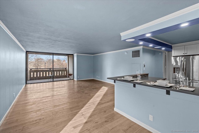 kitchen featuring ornamental molding, white cabinets, light hardwood / wood-style floors, and stainless steel fridge with ice dispenser