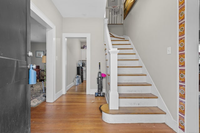 stairway with hardwood / wood-style floors