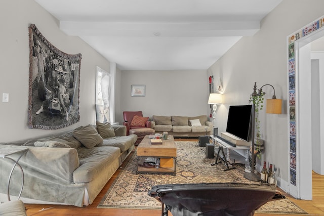 living room featuring beam ceiling and hardwood / wood-style flooring