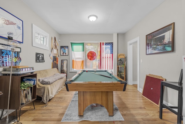 game room with billiards, a healthy amount of sunlight, and light wood-type flooring