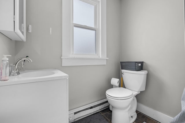 bathroom featuring a baseboard radiator, vanity, tile patterned floors, and toilet