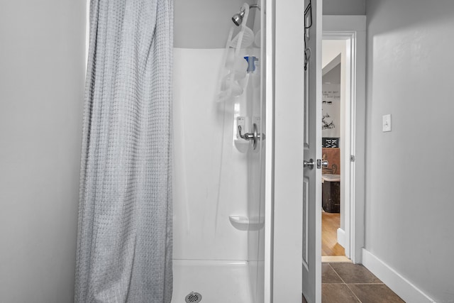 bathroom with tile patterned flooring and a shower with shower curtain