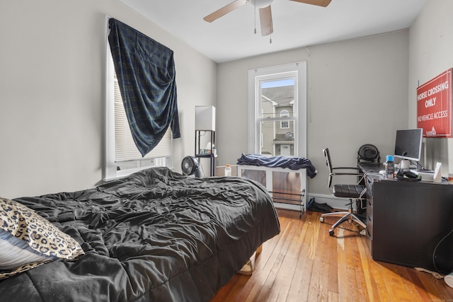 bedroom with hardwood / wood-style floors and ceiling fan