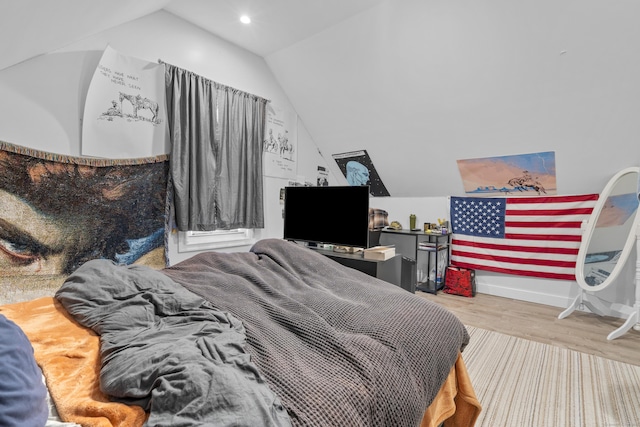 bedroom featuring lofted ceiling and wood-type flooring