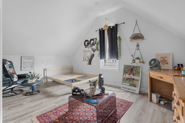 bedroom featuring lofted ceiling and light hardwood / wood-style floors