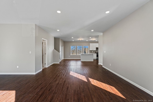 unfurnished living room featuring dark wood-type flooring