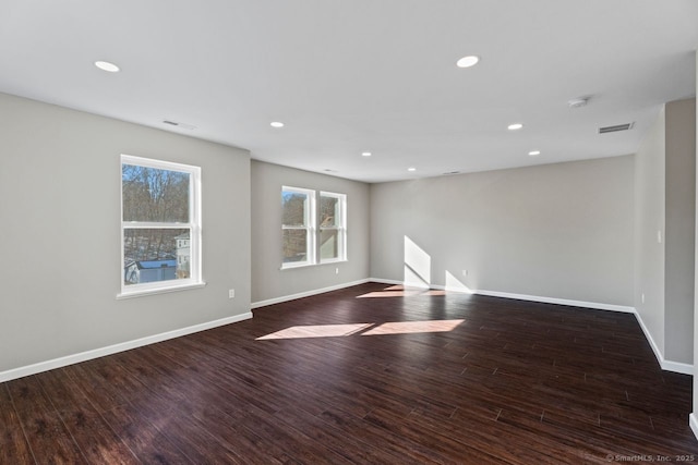 unfurnished room featuring dark wood-type flooring