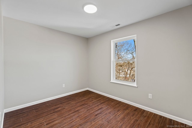 empty room with dark wood-type flooring