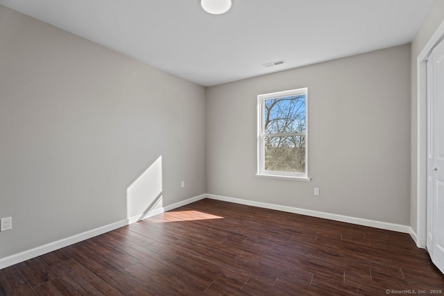 empty room with dark wood-type flooring