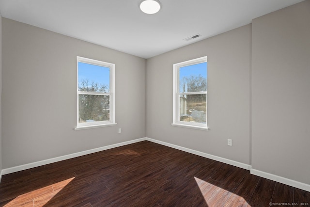 unfurnished room featuring hardwood / wood-style flooring and plenty of natural light