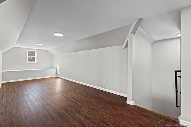 bonus room with vaulted ceiling and dark hardwood / wood-style floors