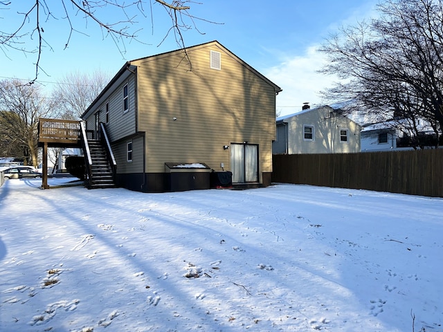 snow covered property featuring a deck