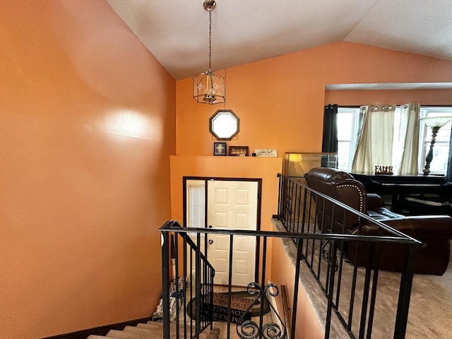 stairway with lofted ceiling and carpet floors