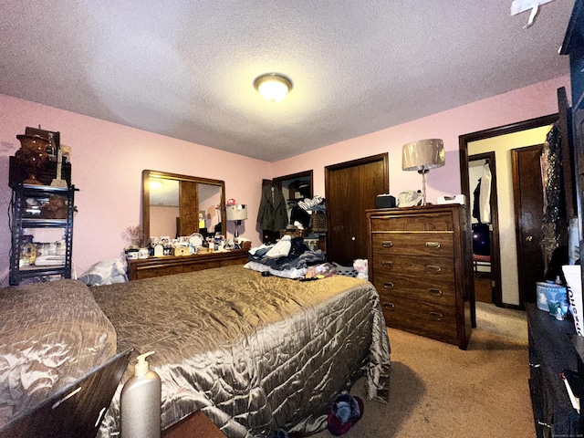 bedroom with light carpet and a textured ceiling