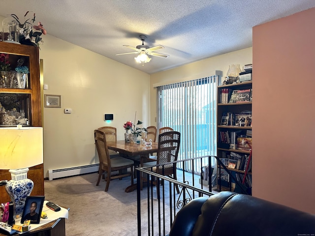 carpeted dining room with a baseboard heating unit, a textured ceiling, and ceiling fan