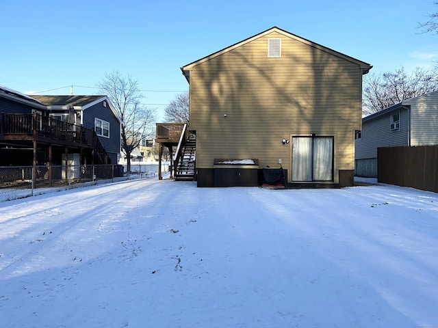 view of snow covered back of property