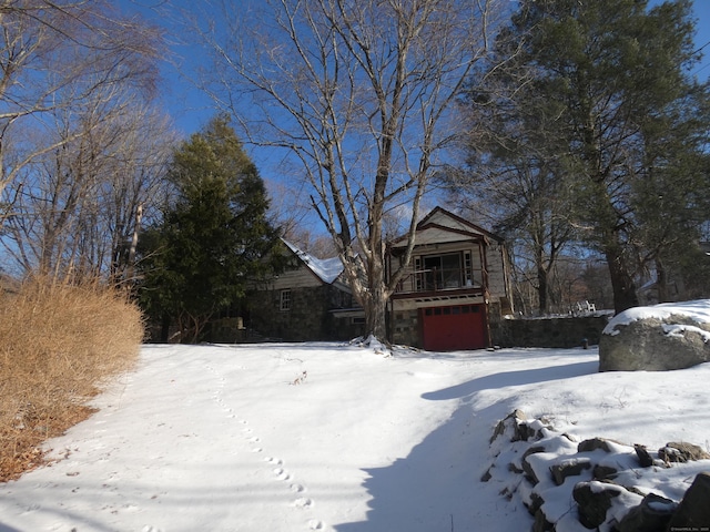 snowy yard featuring a garage