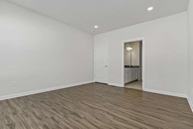 empty room with dark hardwood / wood-style floors