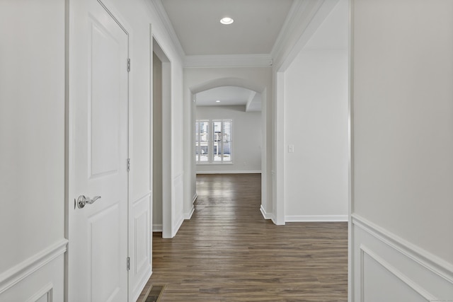 hall with crown molding and dark hardwood / wood-style flooring