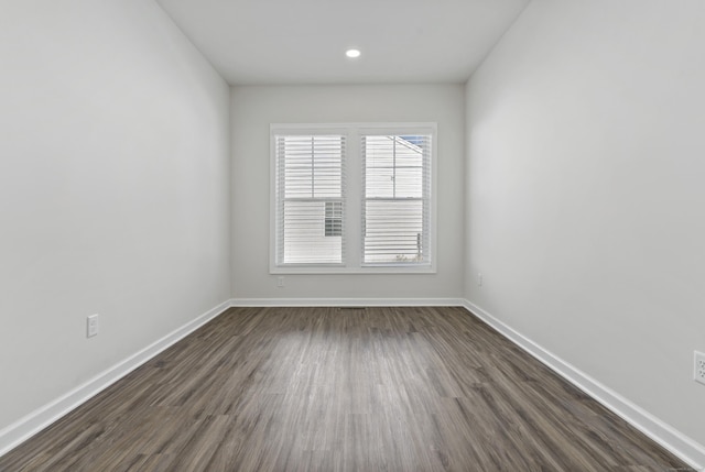 unfurnished room featuring dark hardwood / wood-style flooring