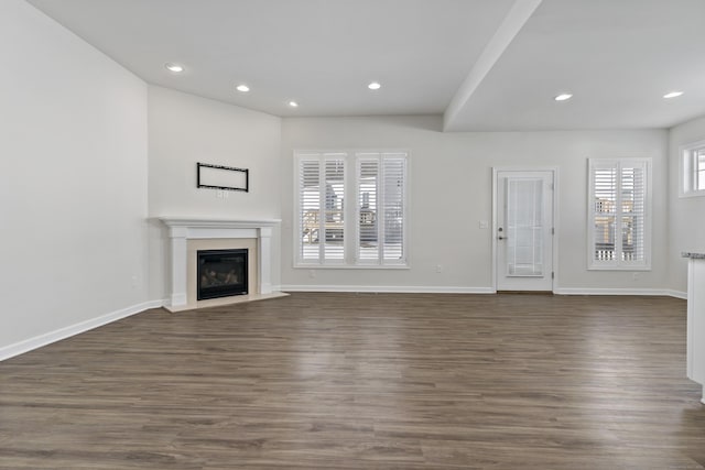 unfurnished living room featuring dark hardwood / wood-style floors